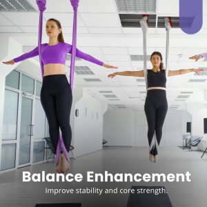  Women balancing in suspended hammocks during an aerial yoga session, enhancing stability and core strength.