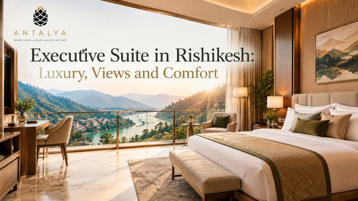 Executive suite in Rishikesh featuring a luxurious king-size bed, elegant interiors, and panoramic Himalayan mountain and river views at Antalya.